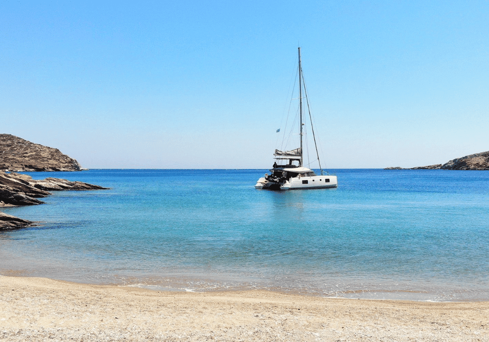A picturesque boat anchored in calm waters as a service from Erossea Villa, providing a stunning backdrop to the tranquil Santorini coastal landscape