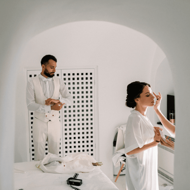 Bride and groum getting ready for her wedding at Erossea Villa, Santorini, with breathtaking scenery and a joyful atmosphere