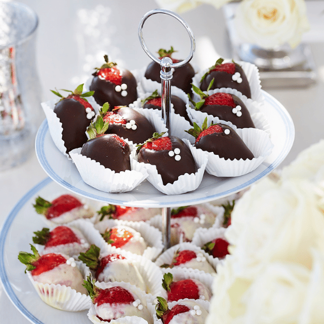 Exquisite chocolate-covered strawberries elegantly arranged on a plate, perfect for a romantic celebration at Erossea Villa Santorini