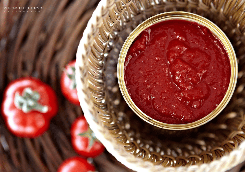 A can of tomato sauce, elegantly displayed, representing culinary delights at Erossea Villa Santorini Luxury Honeymoon