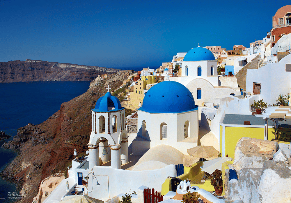 A clear blue sky over the picturesque village of Oia in Santorini, Greece, showcasing its stunning beauty
