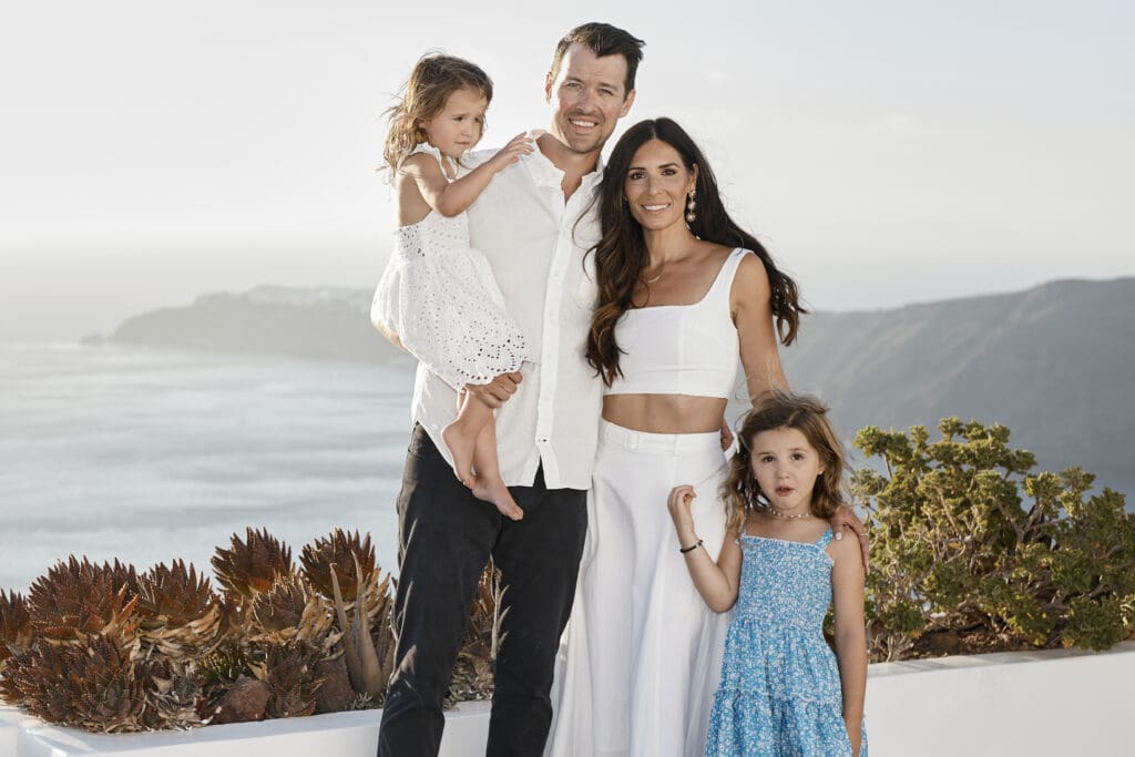 Family enjoying a private villa stay in Santorini with caldera views in Imerovigli