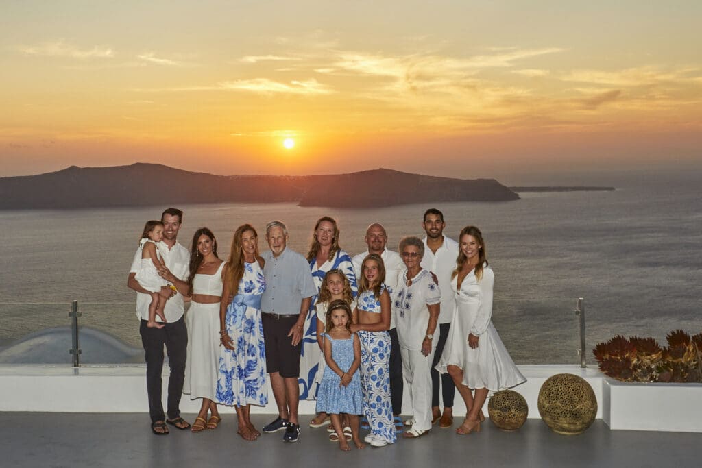 Friends and family sharing sunset at a private villa in Santorini